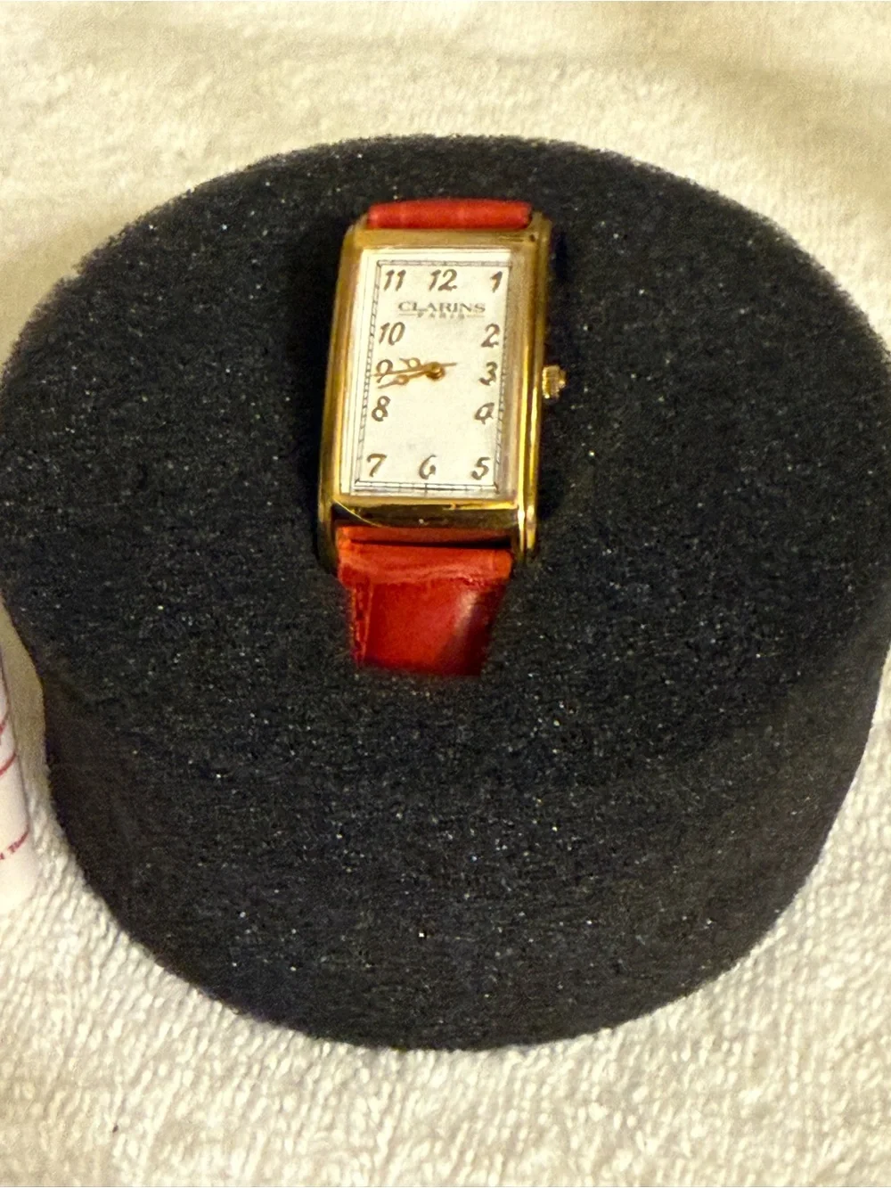 Clarins Gold-Tone Rectangular Watch with Red Strap and White Dial